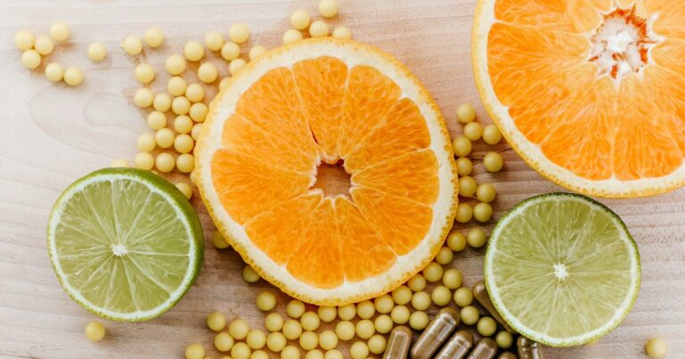 Oranges, limes and vitamins on a table
